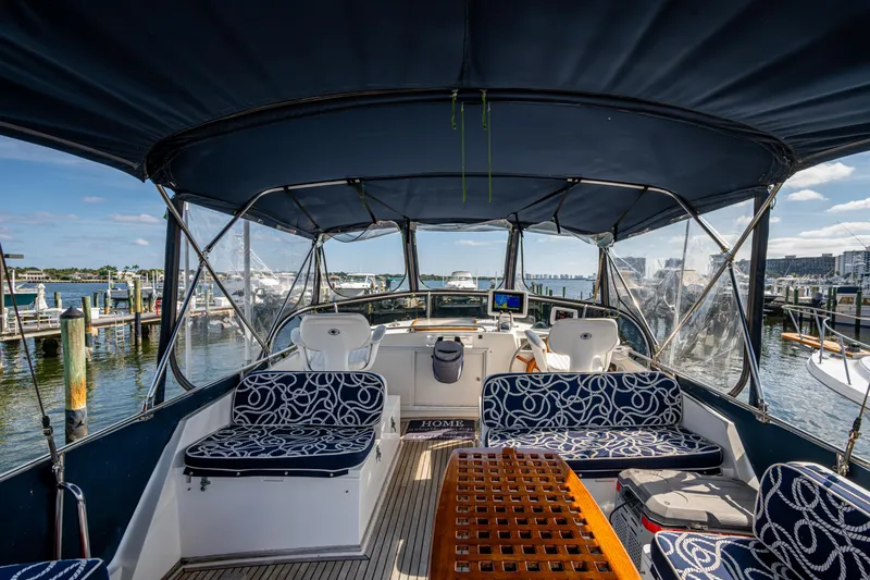  Yacht Photos Pics Grand Banks 42 Classic 2002 yacht interior with seating and wooden table, docked at marina.