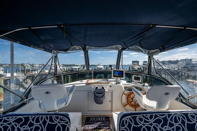  Yacht Photos Pics Interior view of 2002 Grand Banks 42 Classic yacht helm with marina backdrop.