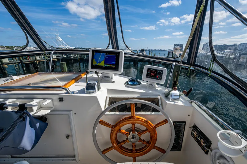  Yacht Photos Pics Helm of 2002 Grand Banks 42 Classic yacht with navigation equipment and wooden steering wheel.