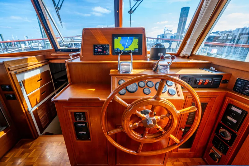  Yacht Photos Pics Helm of 2002 Grand Banks 42 Classic yacht with wooden steering wheel and navigation equipment.