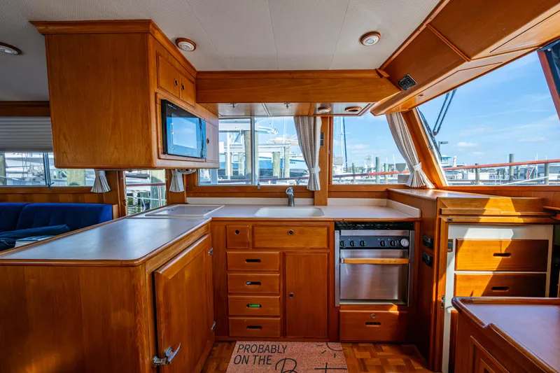  Yacht Photos Pics Interior of 2002 Grand Banks 42 Classic yacht with wooden cabinetry and modern appliances.