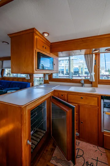  Yacht Photos Pics Interior of 2002 Grand Banks 42 Classic yacht with wooden cabinetry and open fridge.