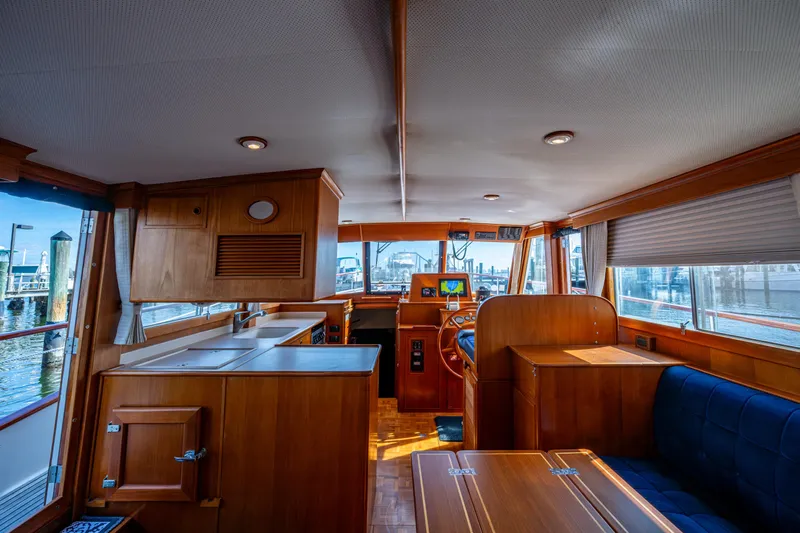  Yacht Photos Pics Interior of 2002 Grand Banks 42 Classic yacht with wooden furnishings and helm station.