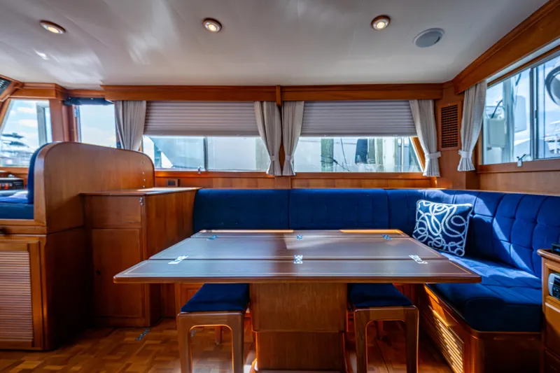  Yacht Photos Pics Interior of 2002 Grand Banks 42 Classic yacht with blue seating and wooden table.