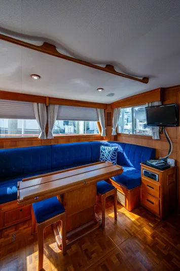  Yacht Photos Pics Interior of 2002 Grand Banks 42 Classic yacht with blue seating and wooden table.