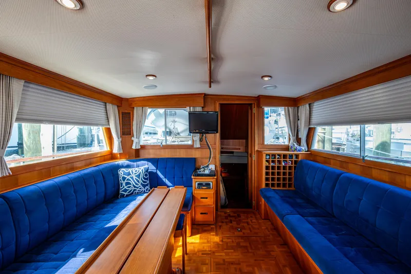  Yacht Photos Pics Interior of 2002 Grand Banks 42 Classic yacht with blue seating and wooden accents.