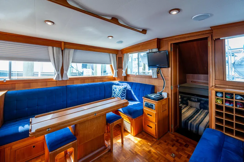  Yacht Photos Pics Interior of 2002 Grand Banks 42 Classic yacht with blue seating and wooden furnishings.