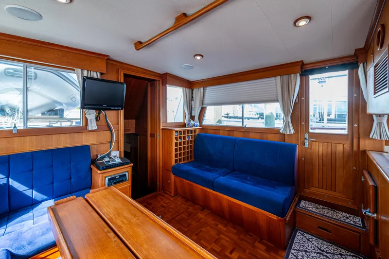  Yacht Photos Pics Interior of 2002 Grand Banks 42 Classic yacht with blue seating and wooden finishes.