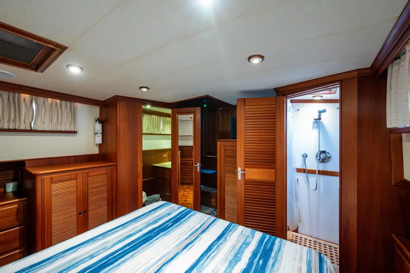  Yacht Photos Pics Interior of 2002 Grand Banks 42 Classic yacht, featuring a cozy bedroom and shower area.