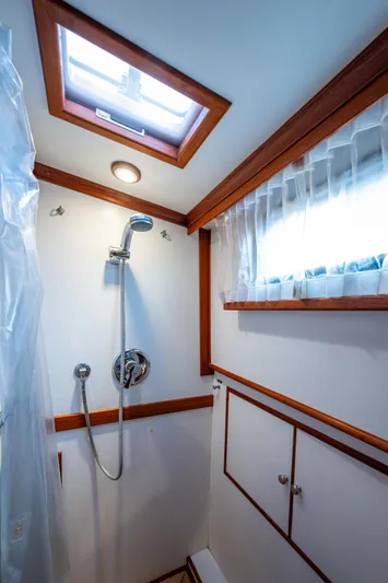  Yacht Photos Pics Shower area in 2002 Grand Banks 42 Classic yacht with wood trim and skylight.