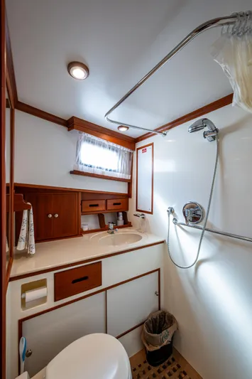  Yacht Photos Pics Bathroom interior of 2002 Grand Banks 42 Classic yacht, featuring wood accents and modern fixtures.