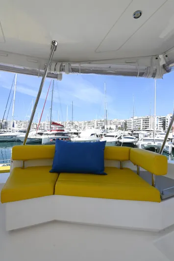  Yacht Photos Pics 2017 Leopard 51 Powercat with yellow seating and blue cushion in a marina setting.