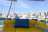 2017 Leopard 51 Powercat with yellow seating and blue cushion in a marina setting.