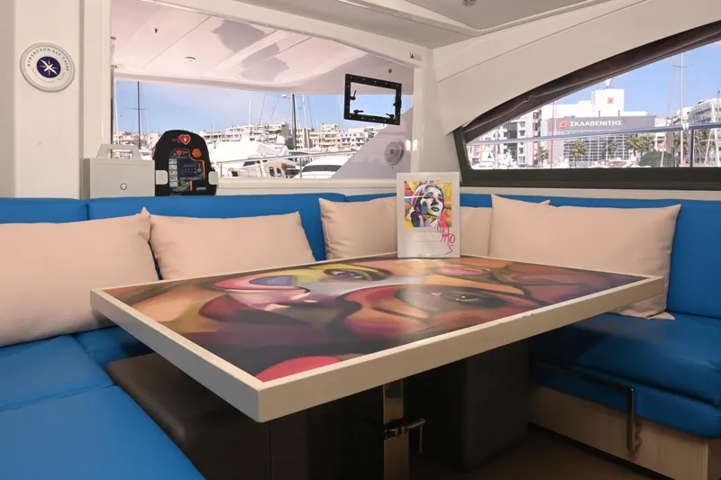  Yacht Photos Pics Interior of 2017 Leopard 51 Powercat with colorful table and blue seating.