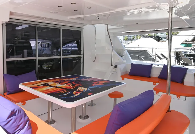  Yacht Photos Pics Outdoor seating area on 2017 Leopard 51 Powercat with vibrant cushions and a colorful table design.