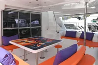 Outdoor seating area on 2017 Leopard 51 Powercat with vibrant cushions and a colorful table design.