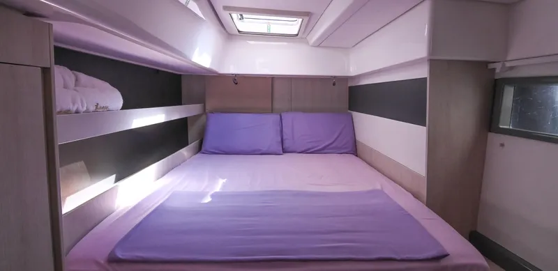  Yacht Photos Pics Luxurious bedroom interior of 2017 Leopard 51 Powercat with purple bedding and modern design.