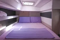 Luxurious bedroom interior of 2017 Leopard 51 Powercat with purple bedding and modern design.
