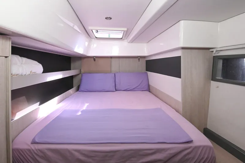  Yacht Photos Pics Luxurious bedroom interior of 2017 Leopard 51 Powercat with purple bedding and modern design.