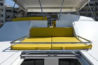 2017 Leopard 51 Powercat with yellow sunbeds and canopy, docked under clear blue sky.