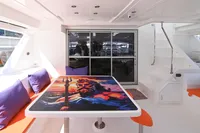 2017 Leopard 51 Powercat interior with vibrant table art and colorful seating.