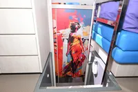 Modern yacht interior with vibrant artwork, featuring colorful abstract painting and sleek furnishings.