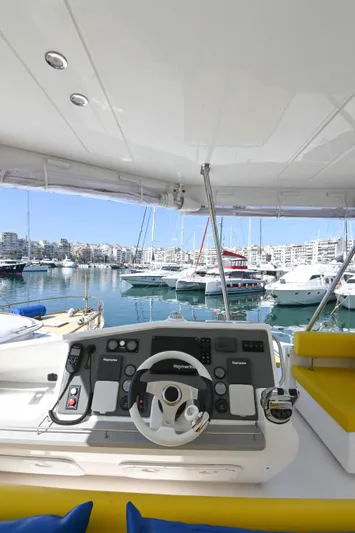  Yacht Photos Pics 2017 Leopard 51 Powercat helm with marina view, featuring modern controls and yellow seating.