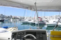2017 Leopard 51 Powercat helm with marina view, featuring modern controls and yellow seating.