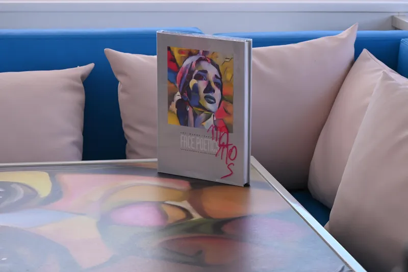  Yacht Photos Pics Art book on colorful table, surrounded by cushions on Leopard 51 Powercat, 2017 model.