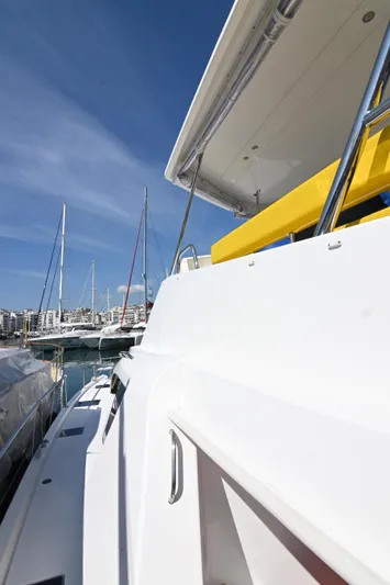  Yacht Photos Pics 2017 Leopard 51 Powercat docked, showcasing sleek design and vibrant yellow seating under clear blue sky.