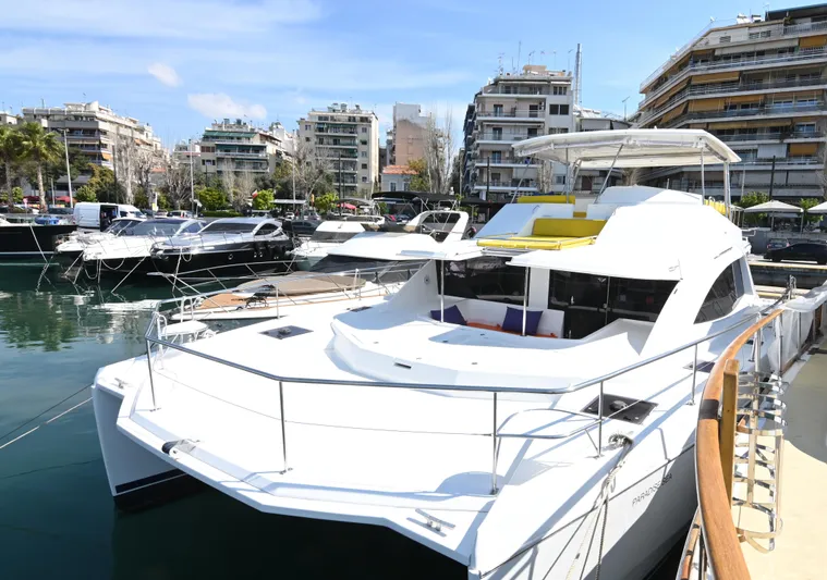  Yacht Photos Pics 2017 Leopard 51 Powercat yacht docked in a marina with cityscape background.