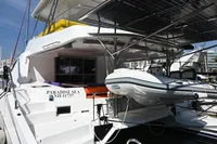 2017 Leopard 51 Powercat yacht with solar panels and dinghy, docked in a marina.