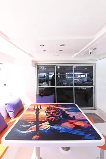  Yacht Photos Pics 2017 Leopard 51 Powercat interior with vibrant artwork on table, purple cushions, and modern design.
