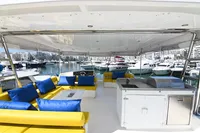 Spacious deck of 2017 Leopard 51 Powercat with vibrant seating and marina view.