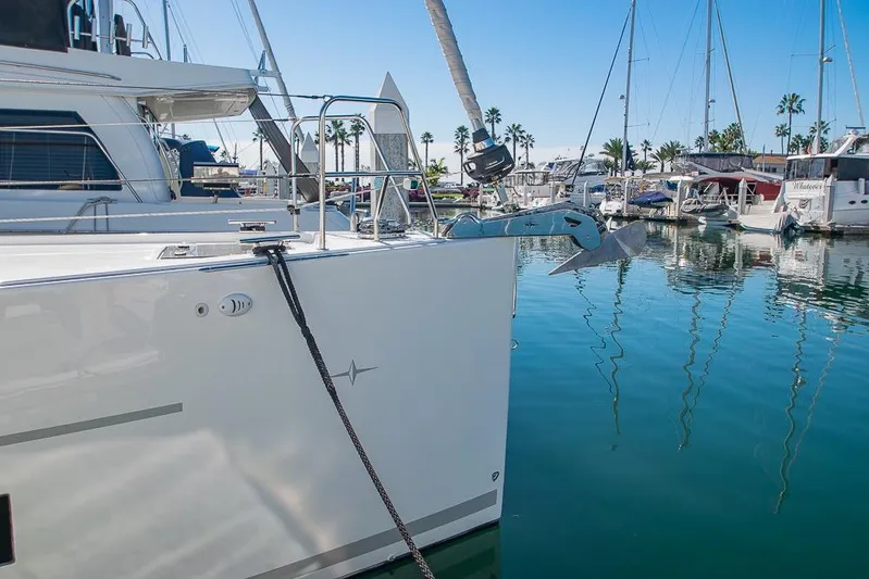  Yacht Photos Pics 2021 Bavaria C45 yacht docked in a marina with clear blue water and sailboats.