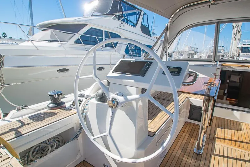  Yacht Photos Pics Steering wheel of 2021 Bavaria C45 yacht with modern navigation system in marina.