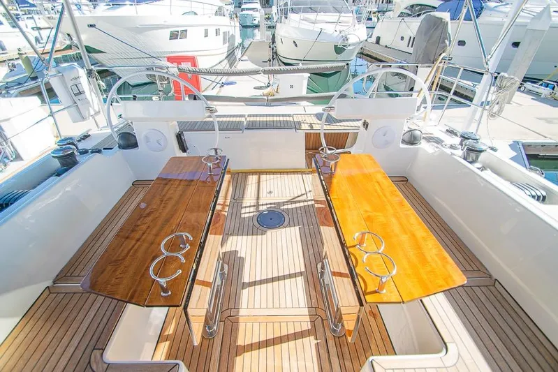 Yacht Photos Pics Spacious deck of 2021 Bavaria C45 yacht with wooden seating and steering wheels.