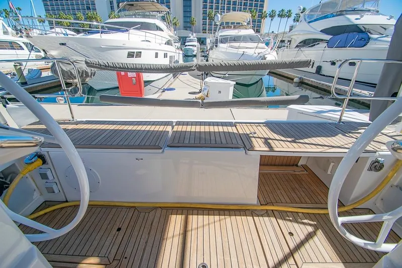  Yacht Photos Pics 2021 Bavaria C45 yacht docked at marina with wooden deck and nearby boats.