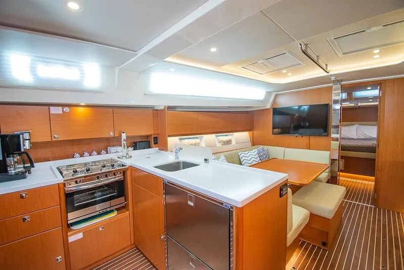  Yacht Photos Pics Luxurious interior of 2021 Bavaria C45 yacht with modern kitchen and cozy seating area.