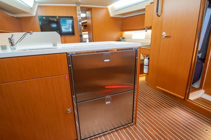 Yacht Photos Pics Interior of 2021 Bavaria C45 yacht with modern kitchen and wooden cabinetry.