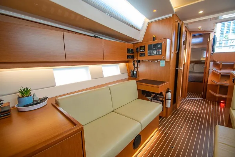  Yacht Photos Pics Modern interior of 2021 Bavaria C45 yacht with wood finish and cozy seating area.