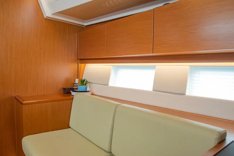  Yacht Photos Pics Interior of 2021 Bavaria C45 yacht with modern wood finish and seating area.