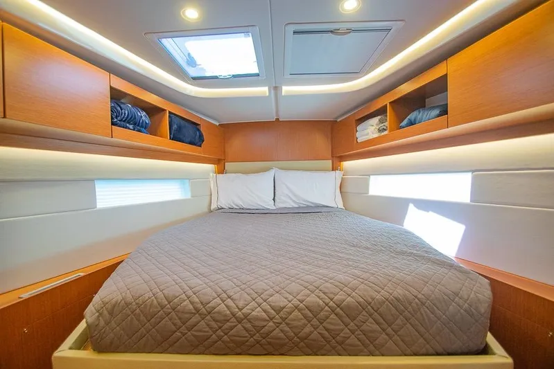  Yacht Photos Pics Luxurious cabin interior of 2021 Bavaria C45 yacht with cozy bedding and ample storage.