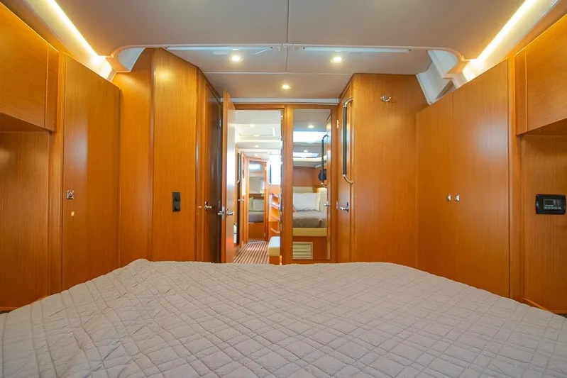  Yacht Photos Pics Luxurious interior of 2021 Bavaria C45 yacht with wood finish and cozy bedding.