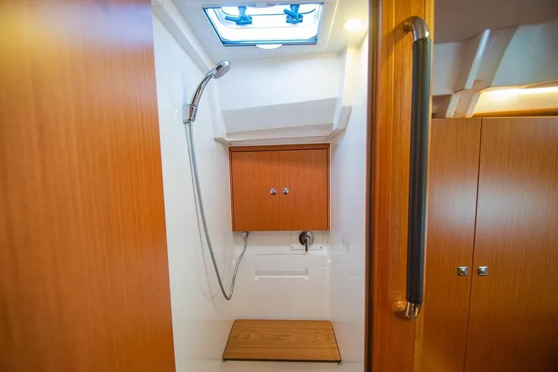  Yacht Photos Pics 2021 Bavaria C45 yacht shower with wooden accents and modern fixtures.