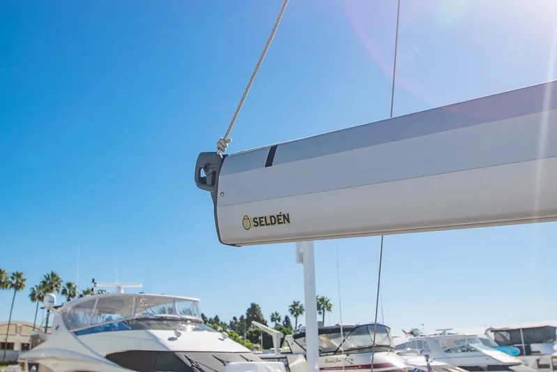  Yacht Photos Pics Sailboat Bavaria C45 (2021) with Selden boom, docked under clear blue sky.