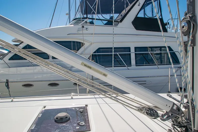  Yacht Photos Pics Sailboat Bavaria C45 (2021) with Selden boom, docked near a larger yacht.