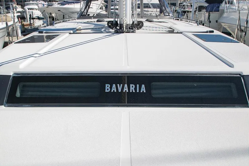  Yacht Photos Pics 2021 Bavaria C45 yacht deck with brand logo, docked in marina.