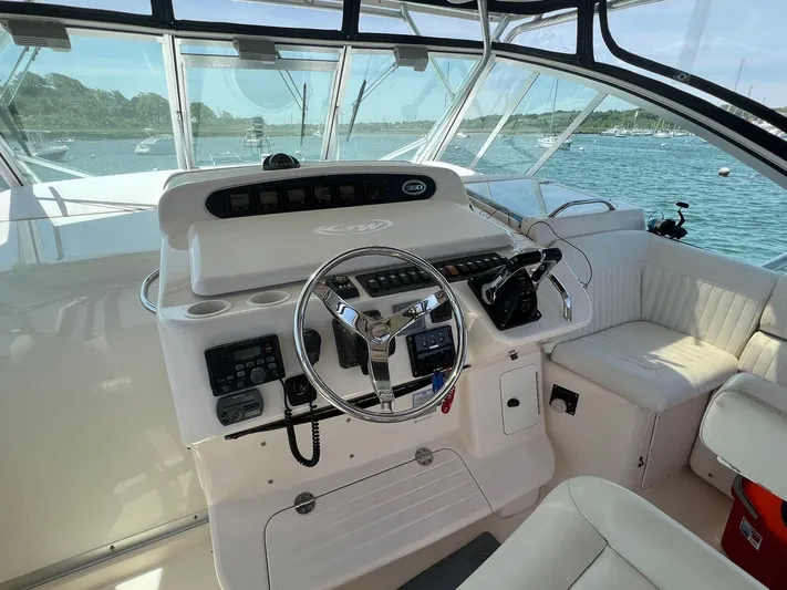  Yacht Photos Pics 2006 Grady-White Express 360 helm with steering wheel and controls, overlooking a scenic marina.
