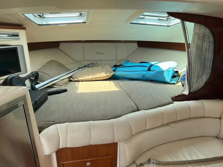  Yacht Photos Pics 2006 Grady-White Express 360 cabin interior with bed, fishing gear, and storage.